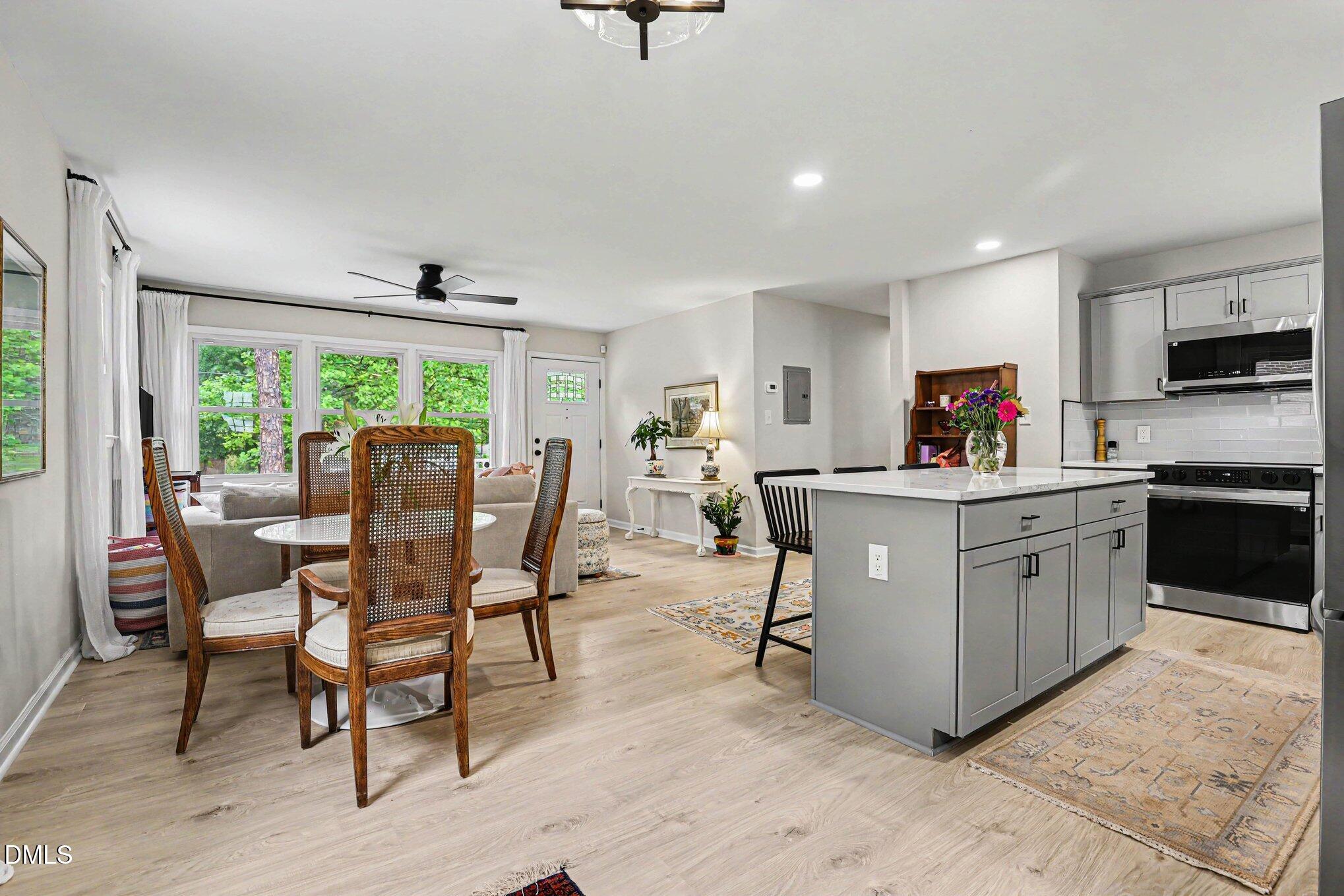 824 Carlisle Street Raleigh, NC 27610 - Photo 10 of 20 Gather around the dining table or the island.