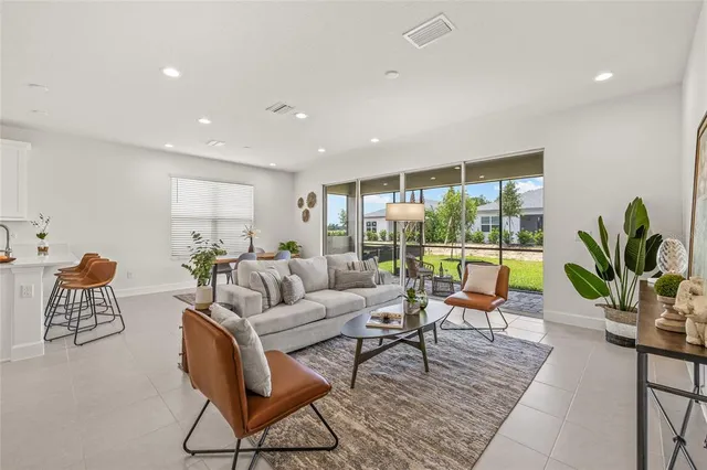 a living room with furniture and a large window
