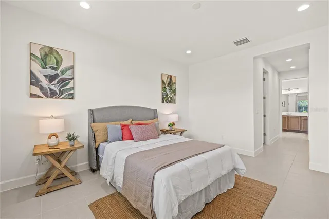 a bedroom with a bed and a view of kitchen