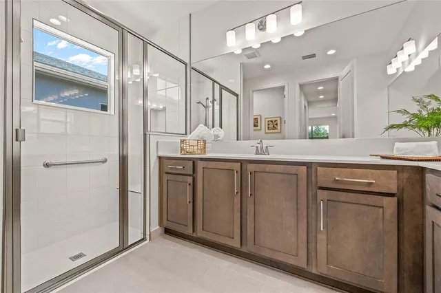 a bathroom with a double vanity sink and a mirror