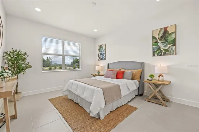 a bedroom with a bed and a window