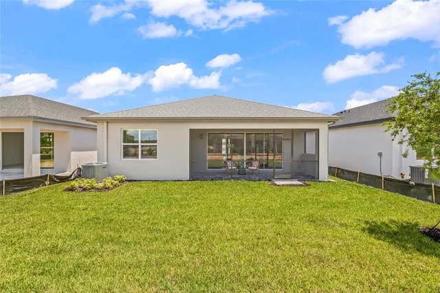 a view of a house with backyard sitting area and garden