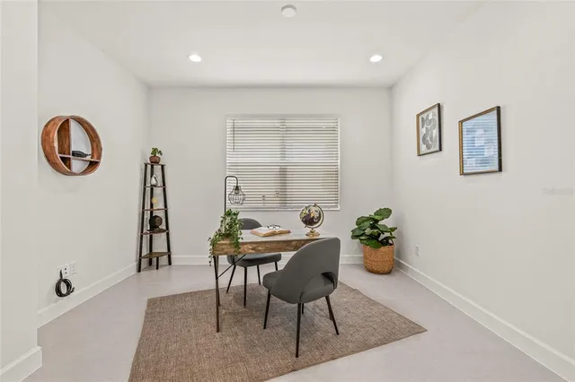 a dining room with furniture and wooden floor