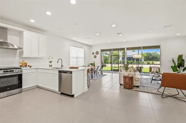 a kitchen with a large window in a living room