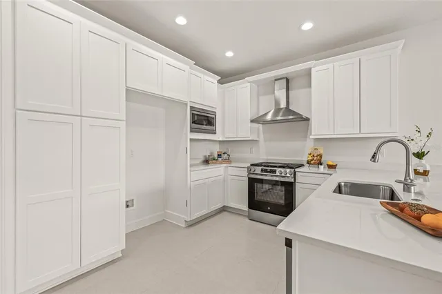 a kitchen with cabinets and stainless steel appliances
