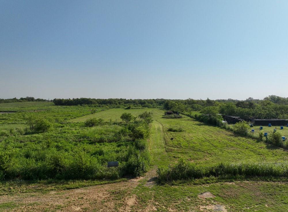 6594 County Road 140 Kaufman, TX 75142 - Photo 7 of 15 a view of a green field with a lake