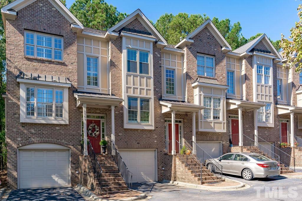 1303 Cameron View Court Raleigh, NC 27608 - Photo 2 of 30 a front view of a building with many windows