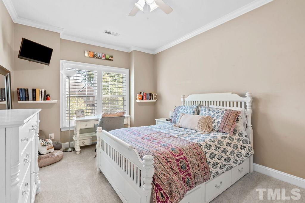1303 Cameron View Court Raleigh, NC 27608 - Photo 13 of 30 a bedroom with a bed and a flat screen tv
