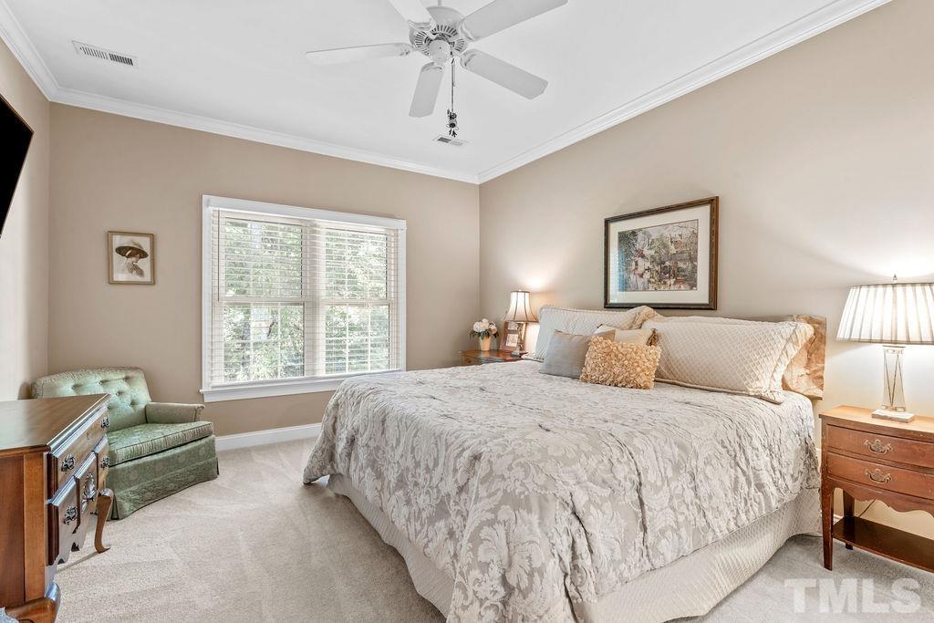 1303 Cameron View Court Raleigh, NC 27608 - Photo 18 of 30 a spacious bedroom with a large bed and a window