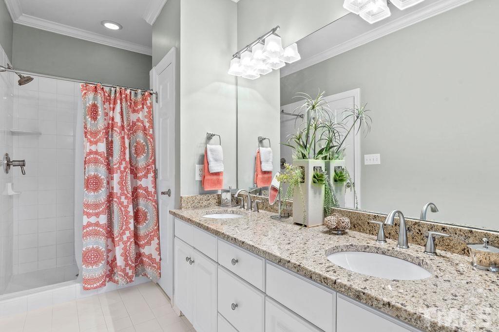 1303 Cameron View Court Raleigh, NC 27608 - Photo 21 of 30 a bathroom with a granite countertop sink and a mirror