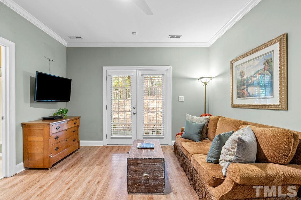 1303 Cameron View Court Raleigh, NC 27608 - Photo 23 of 30 a living room with furniture and a flat screen tv