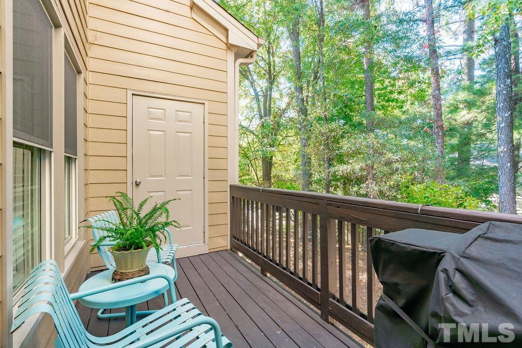 1303 Cameron View Court Raleigh, NC 27608 - Photo 26 of 30 a view of a balcony with chair and wooden floor