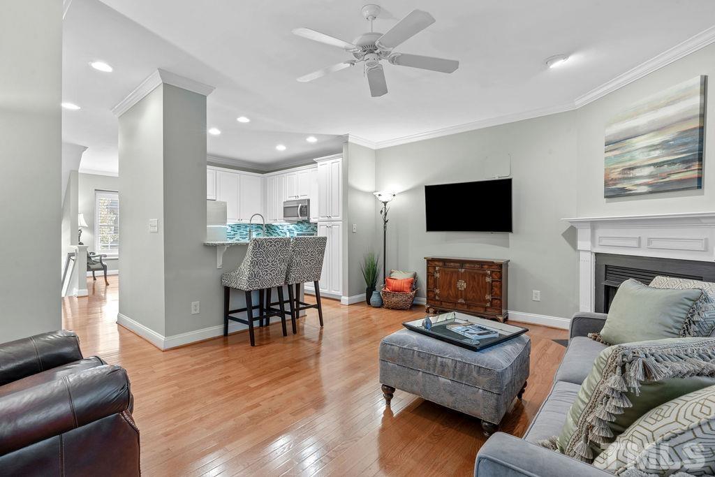 1303 Cameron View Court Raleigh, NC 27608 - Photo 9 of 30 a living room with furniture and a flat screen tv