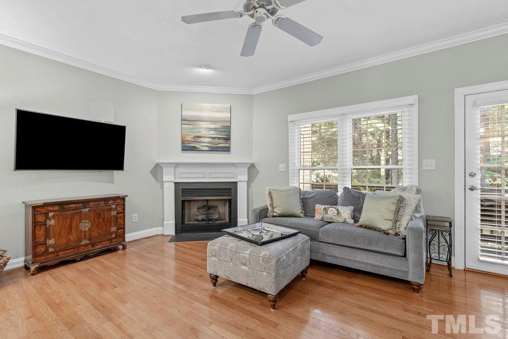 1303 Cameron View Court Raleigh, NC 27608 - Photo 10 of 30 a living room with furniture a flat screen tv and a fireplace