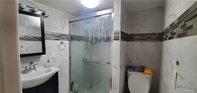 a bathroom with a sink toilet and shower