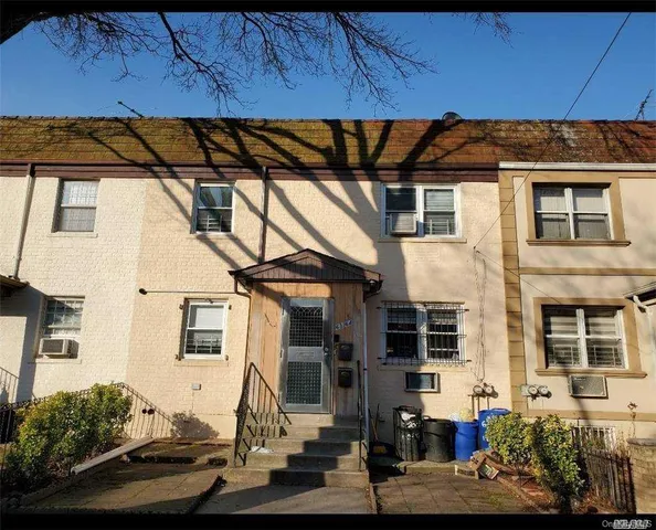 a living room with furniture and a hallway