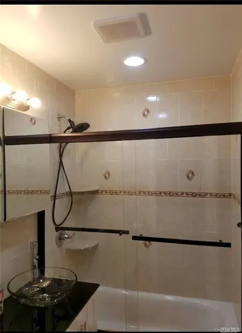 a bathroom with a shower and a mirror