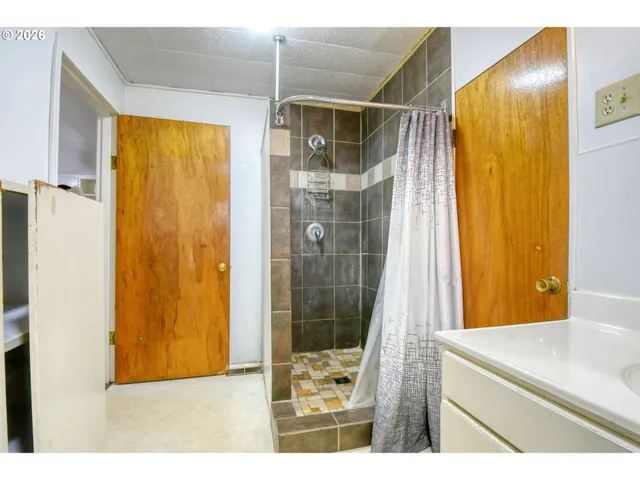 a bathroom with a shower and a sink