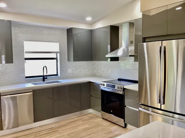 a kitchen with a refrigerator and a sink
