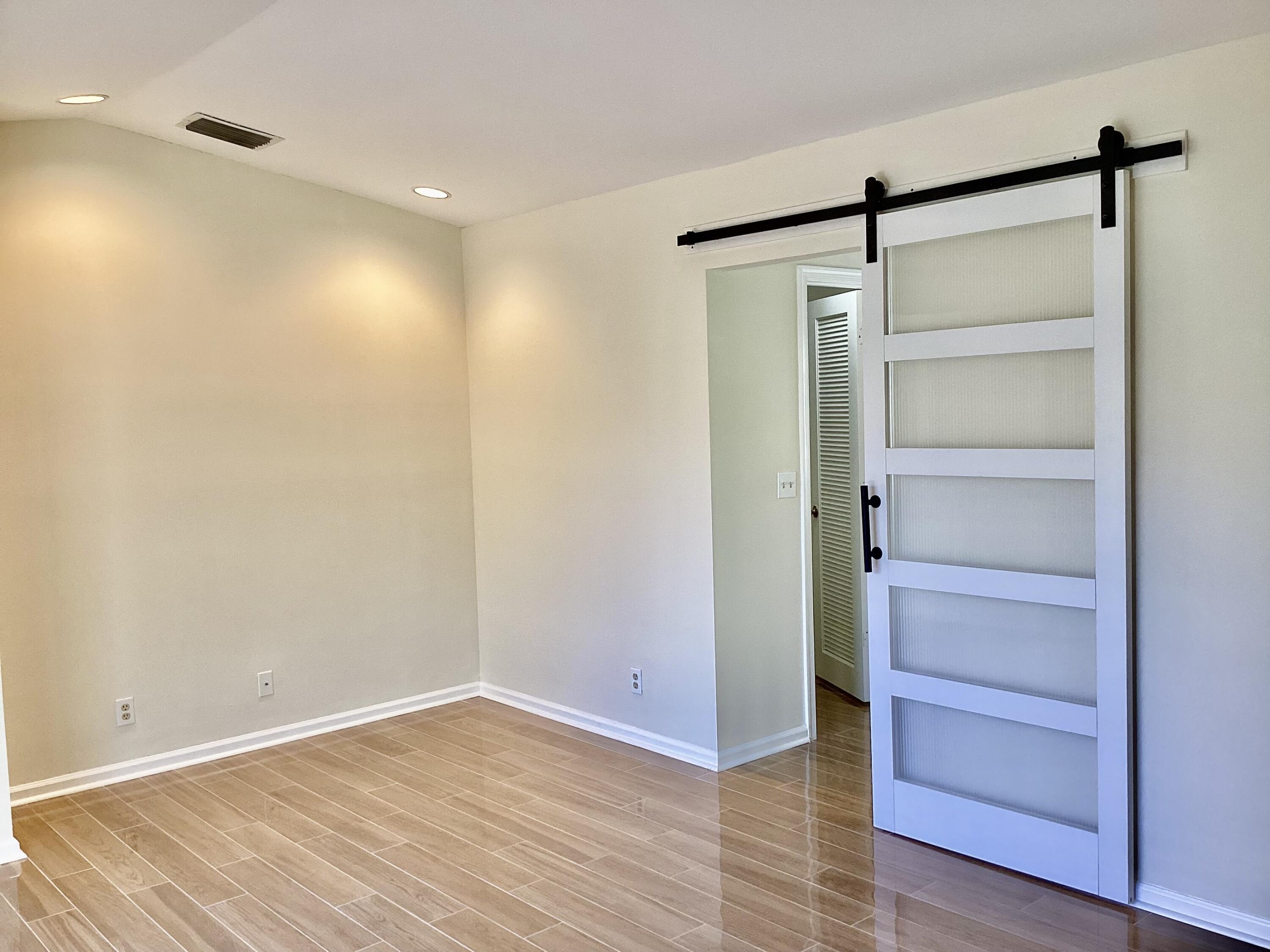 8895 Old Pine Road, Unit 4 Boca Raton, FL 33433 - Photo 19 of 46 a view of an empty room with wooden floor