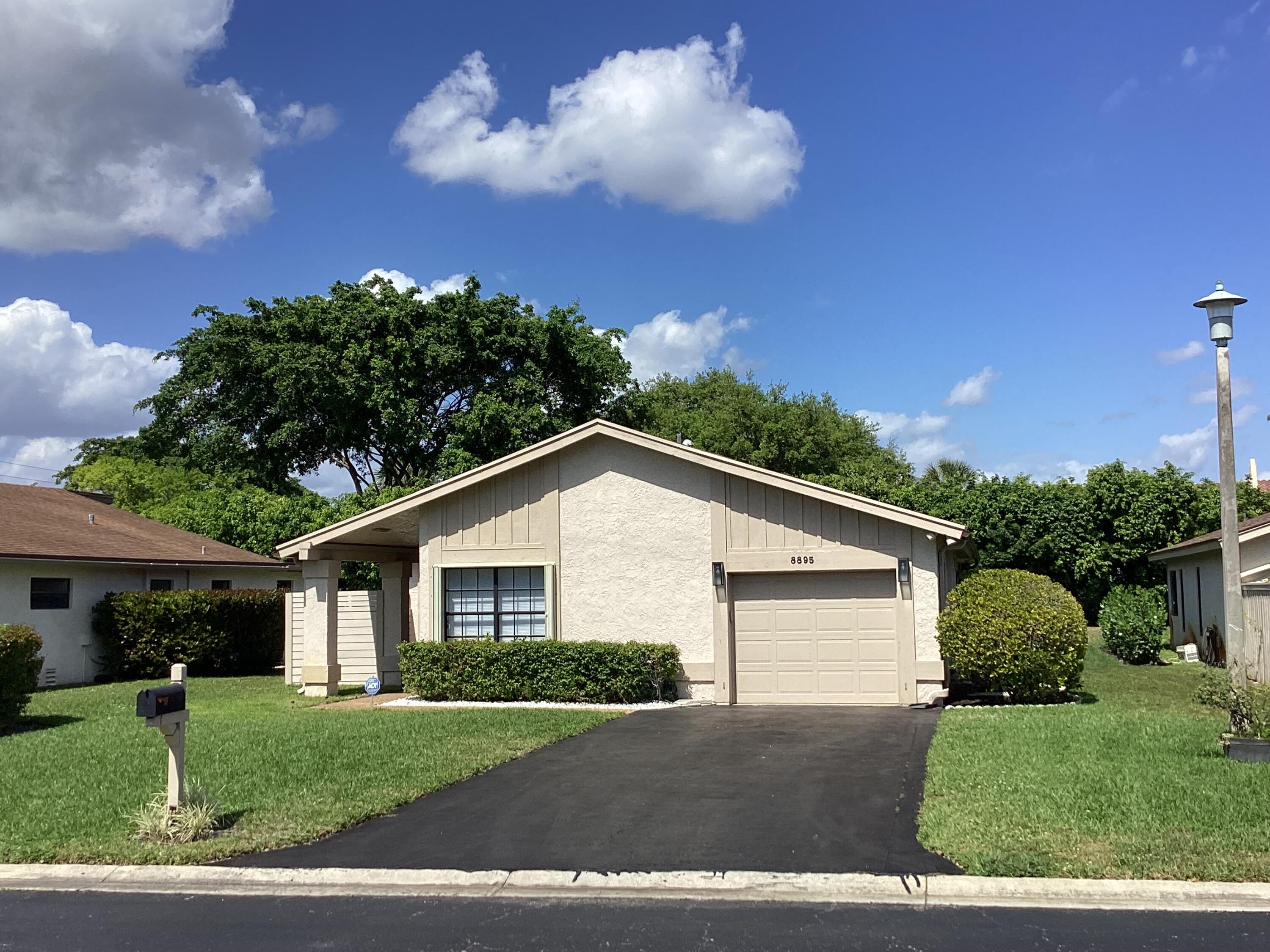 8895 Old Pine Road, Unit 4 Boca Raton, FL 33433 - Photo 2 of 46 a view of a house with a yard