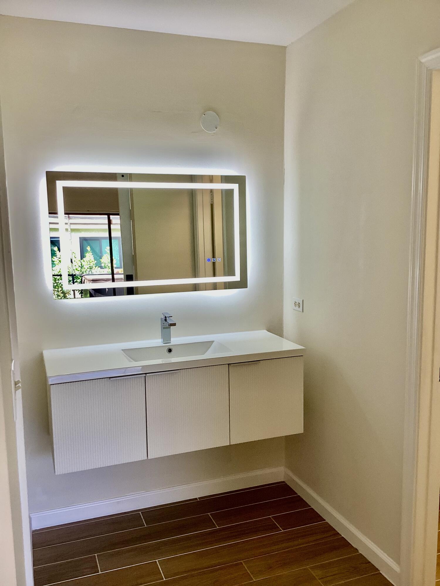 8895 Old Pine Road, Unit 4 Boca Raton, FL 33433 - Photo 20 of 46 a bathroom with a sink and a mirror