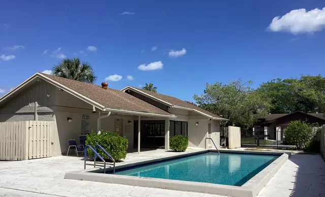a view of house with outdoor space and swimming pool