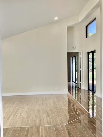 a view of an empty room with glass door