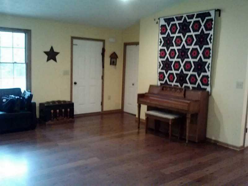 1262 Hartzell Road New Castle, PA 16105 - Photo 4 of 21 Living Room. Easy clean laminated flooring, kitchen, dining, and livingroom
