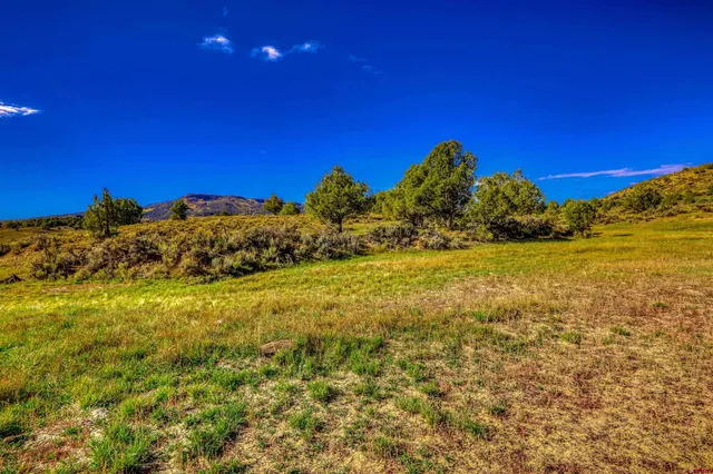 a view of a large body of water with a house in the background