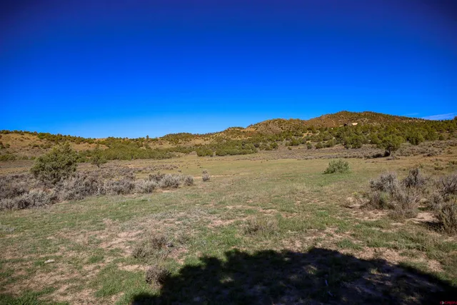 a view of a large mountain with mountains in the background