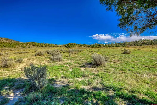 a view of a large mountain with mountains in the background