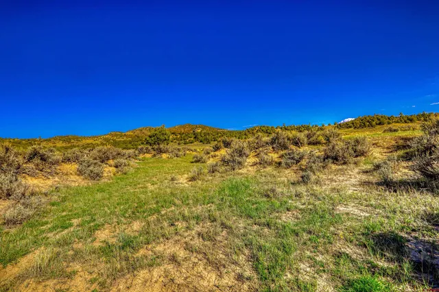 a view of a large mountain with mountains in the background