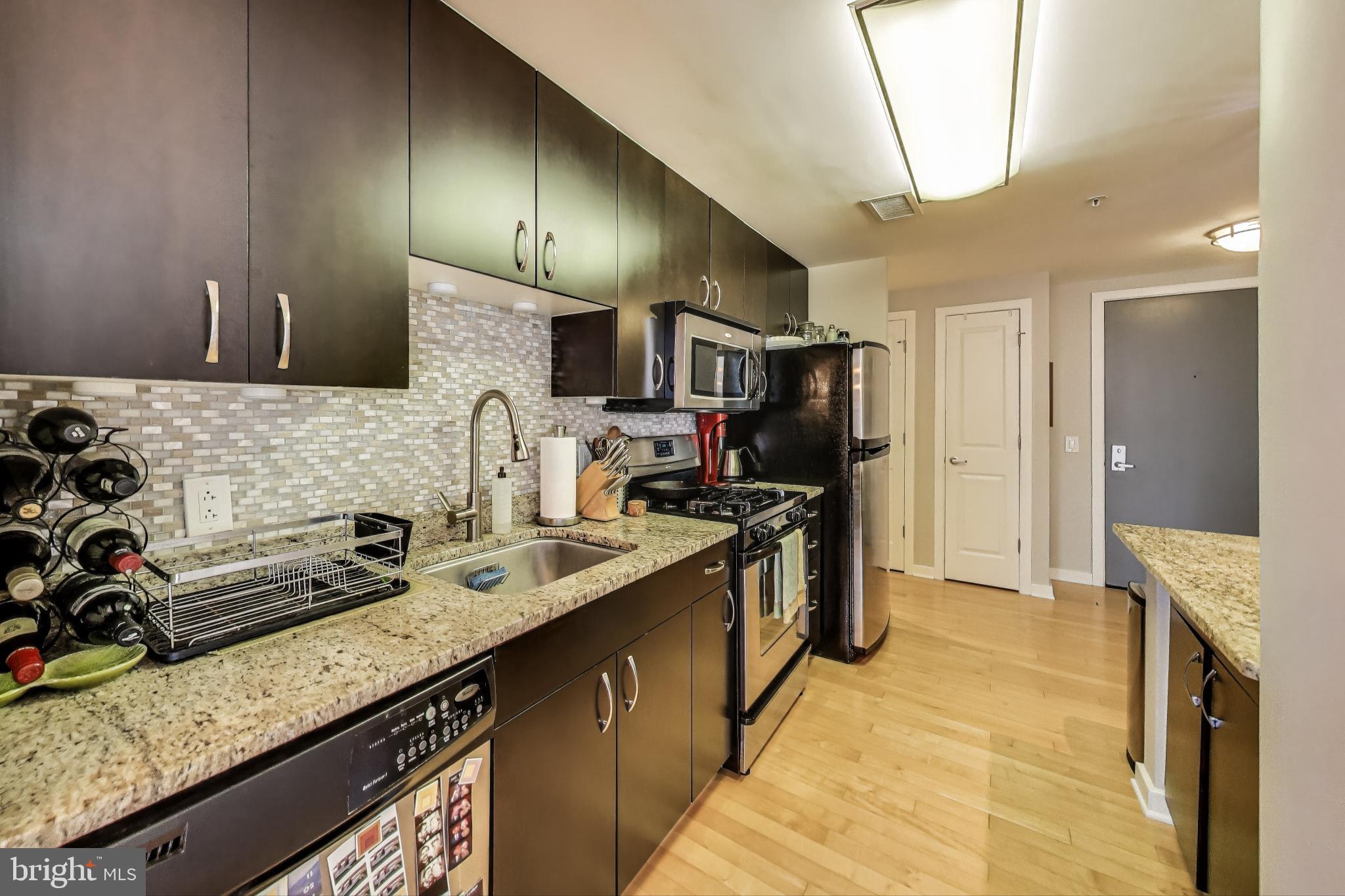 475 K Street Northwest, Unit 919 Washington, DC 20001 - Photo 11 of 43 a kitchen with stainless steel appliances granite countertop a sink stove and refrigerator