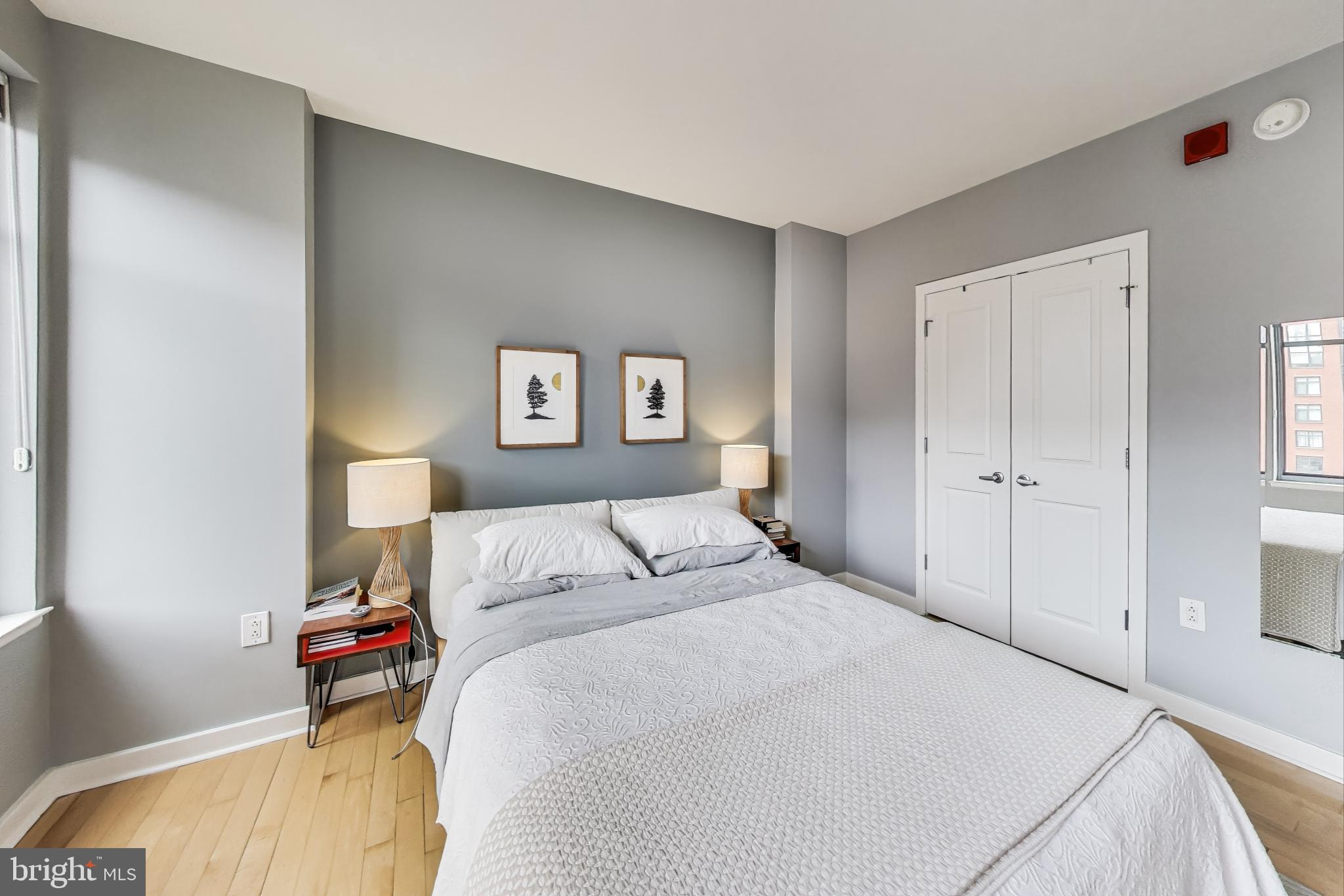 475 K Street Northwest, Unit 919 Washington, DC 20001 - Photo 14 of 43 a bedroom with a bed and a painting on the wall