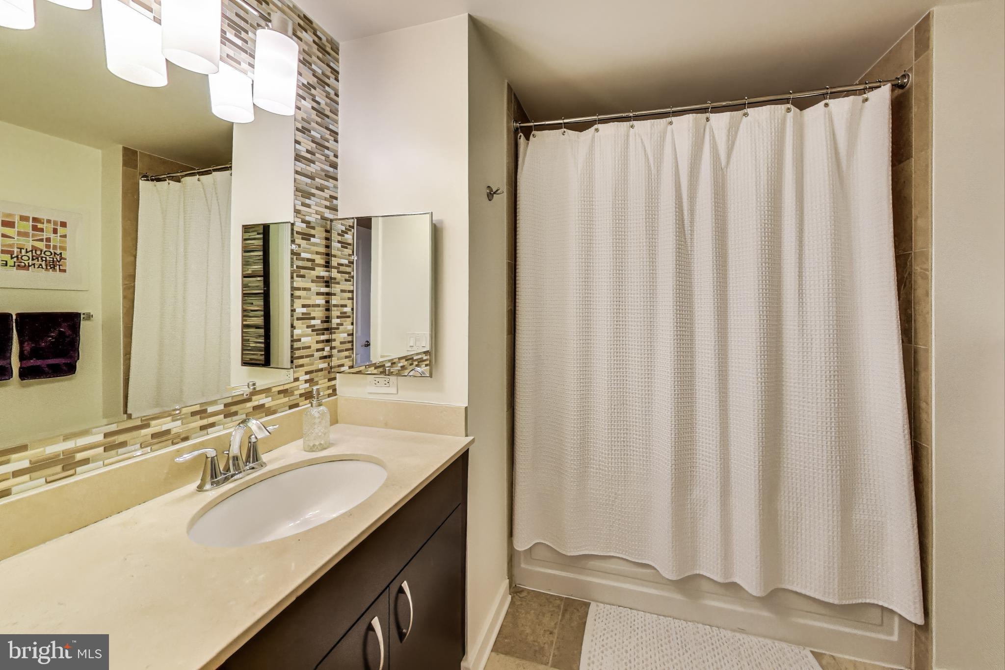 475 K Street Northwest, Unit 919 Washington, DC 20001 - Photo 20 of 43 a bathroom with a double vanity sink and a mirror