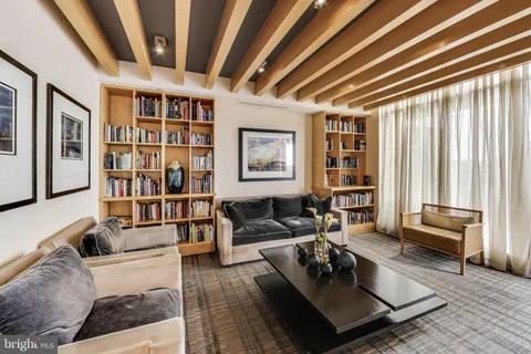 a living room with furniture and a book shelf