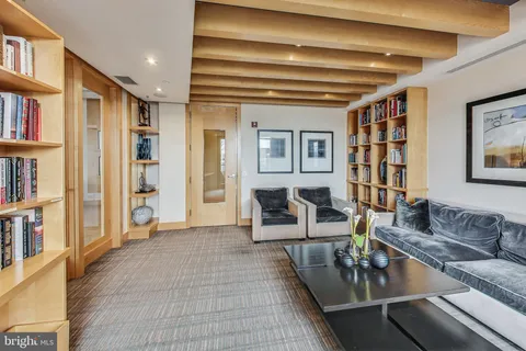 a living room with furniture and a book shelf