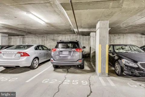 a view of parking garage with cars parked