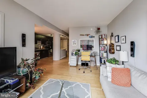 a living room with patio furniture and a flat screen tv