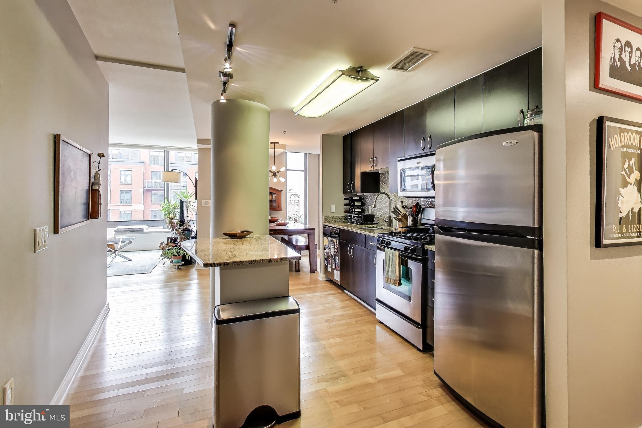 475 K Street Northwest, Unit 919 Washington, DC 20001 - Photo 10 of 43 a kitchen with stainless steel appliances granite countertop a refrigerator a stove and a wooden floors