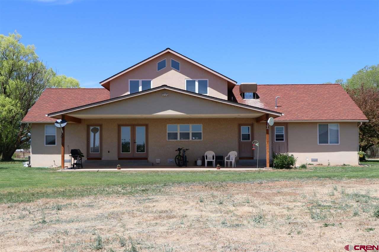 23720 County Rd M Cortez, CO 81321 - Photo 1 of 34 a front view of a house with a yard