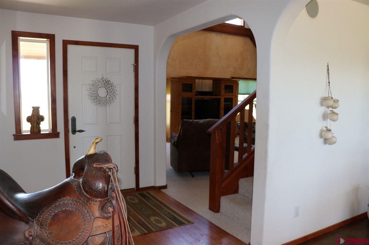 23720 County Rd M Cortez, CO 81321 - Photo 14 of 34 a view of entryway and hall with wooden floor