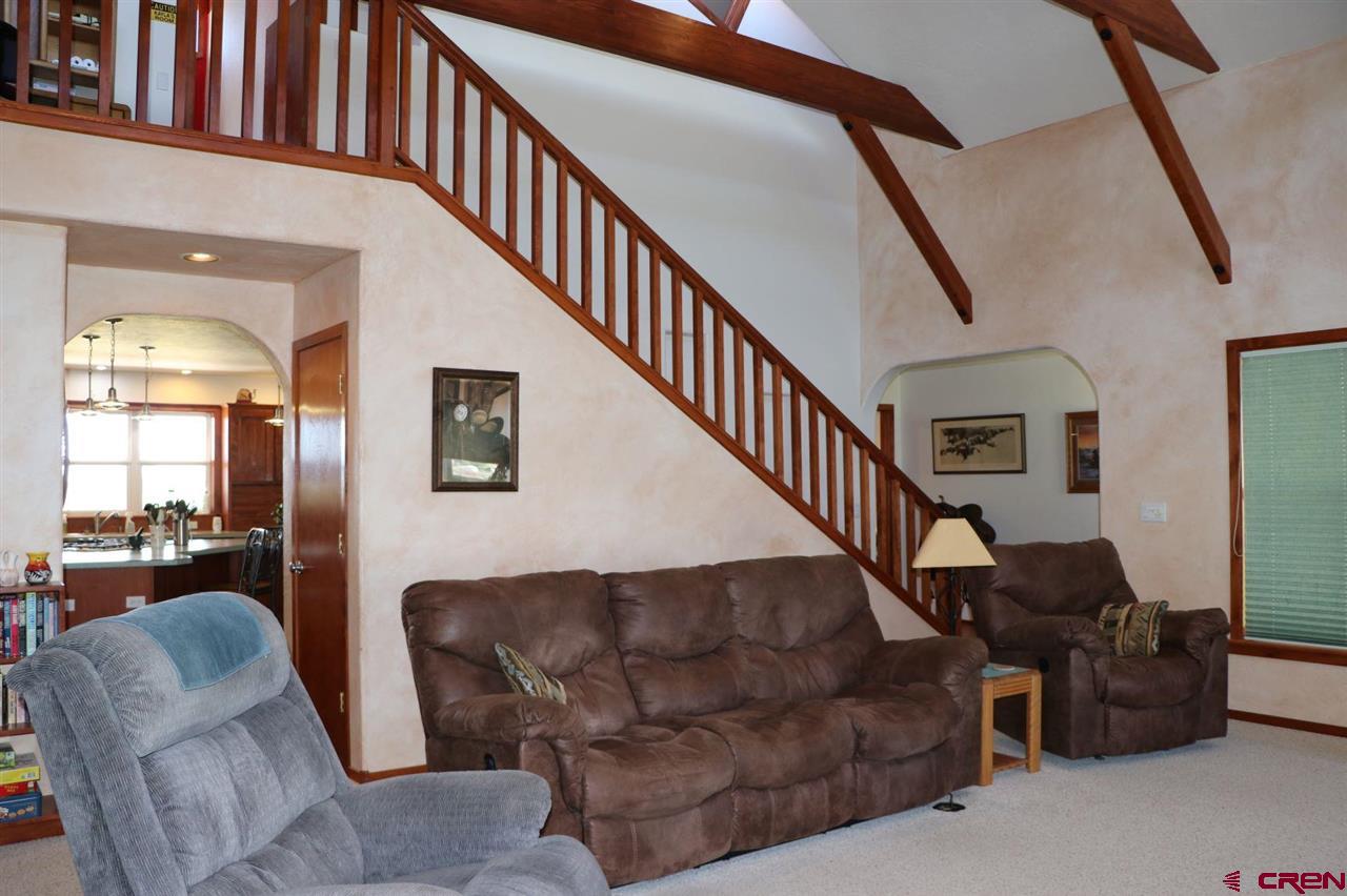 23720 County Rd M Cortez, CO 81321 - Photo 15 of 34 a living room with furniture and a staircase