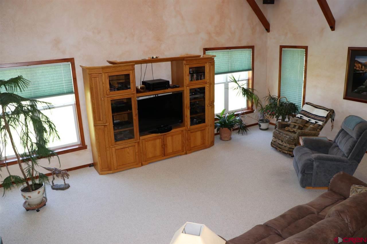23720 County Rd M Cortez, CO 81321 - Photo 17 of 34 a living room with furniture gym equipment and large windows