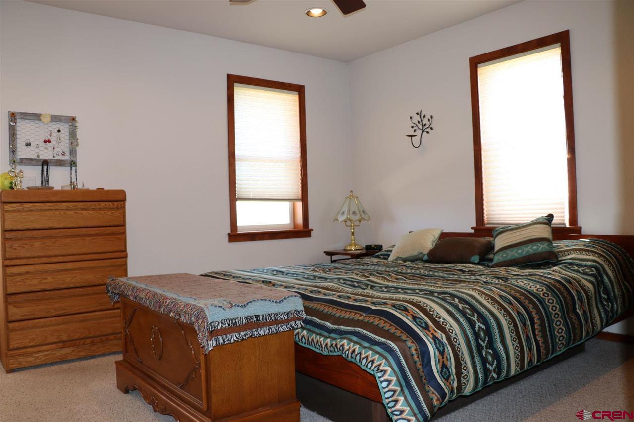 23720 County Rd M Cortez, CO 81321 - Photo 19 of 34 a bed sitting in a bedroom next to a window