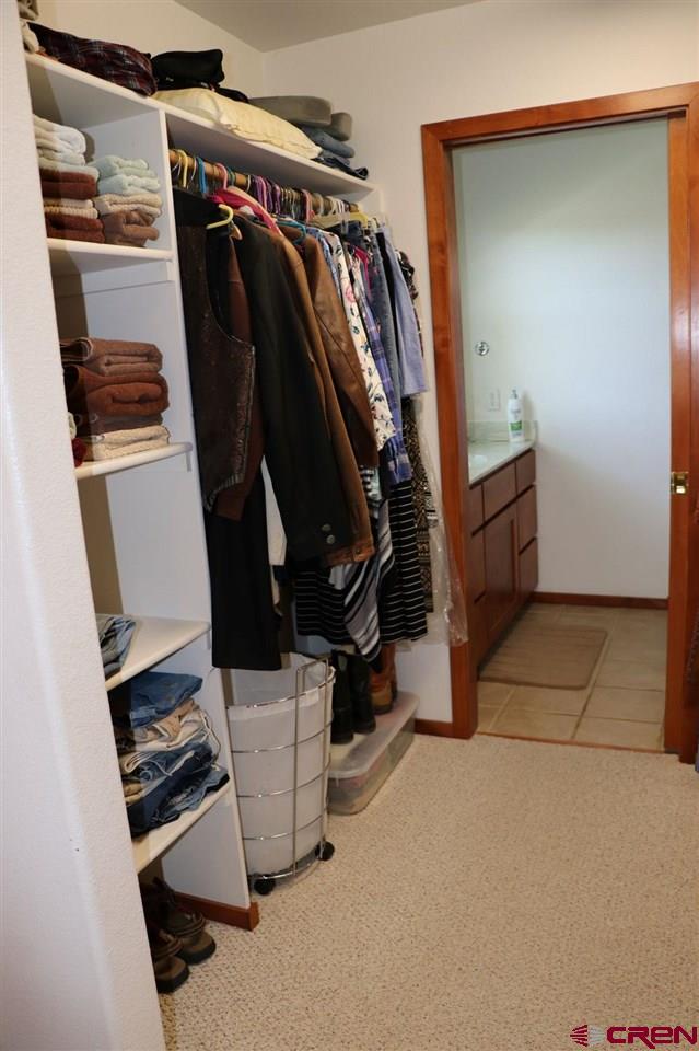 23720 County Rd M Cortez, CO 81321 - Photo 20 of 34 a view of walk in closet with clothes and shoes
