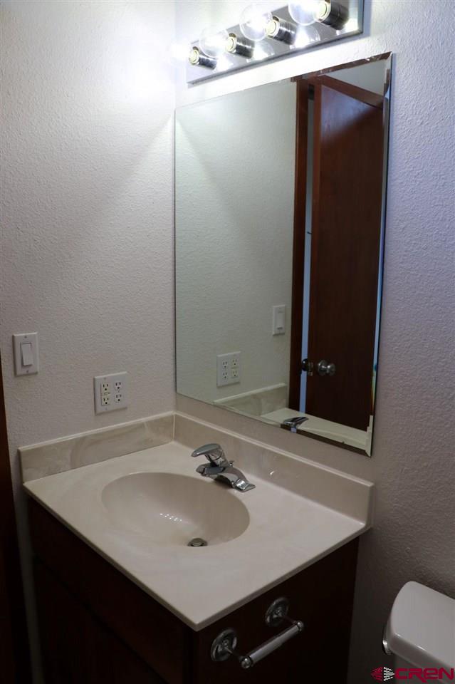 23720 County Rd M Cortez, CO 81321 - Photo 23 of 34 a bathroom with a sink and a mirror