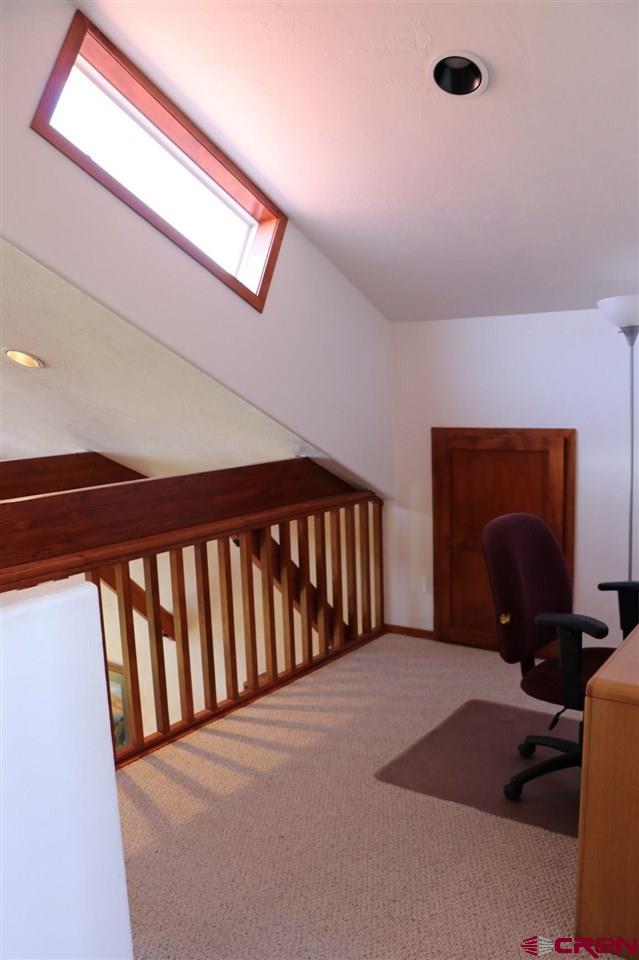 23720 County Rd M Cortez, CO 81321 - Photo 25 of 34 a bedroom with a bed and a dresser