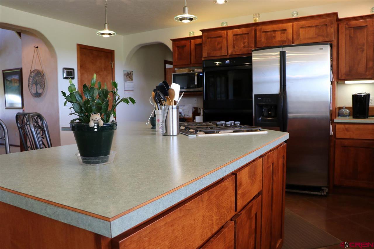 23720 County Rd M Cortez, CO 81321 - Photo 29 of 34 a kitchen with a refrigerator and a sink